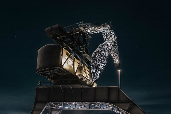 Luleå industrial cargo crane at night with lit cabin