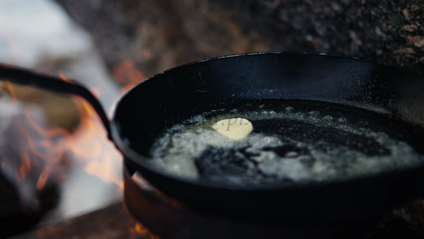 Melting Butter in a Cast Iron Pan Over a Campfire in the Luleå Archipelago During Winter