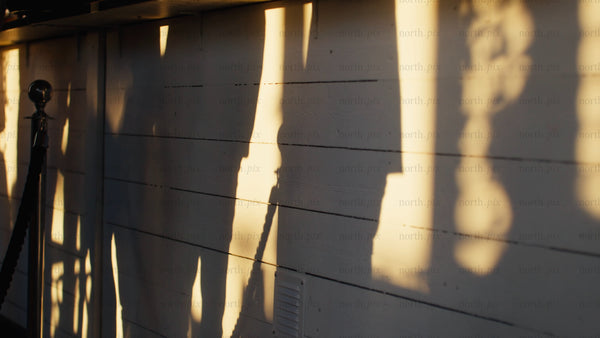 Golden hour shadows on a white wall in Luleå: A summer travel video