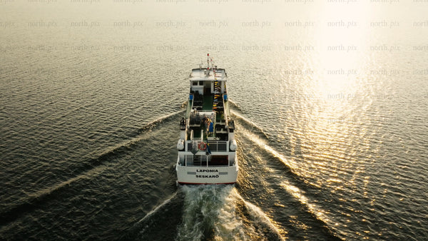 Ferry in Luleå archipelago at sunset: Laponia seskarö, golden hour, aerial view