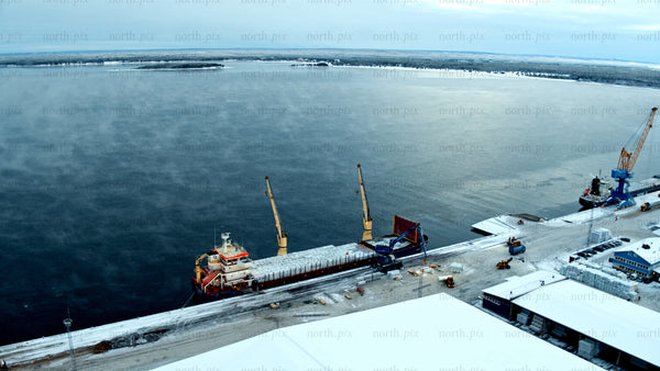 Aerial view of Piteå Haraholmen harbour in snowy winter with cargo ships