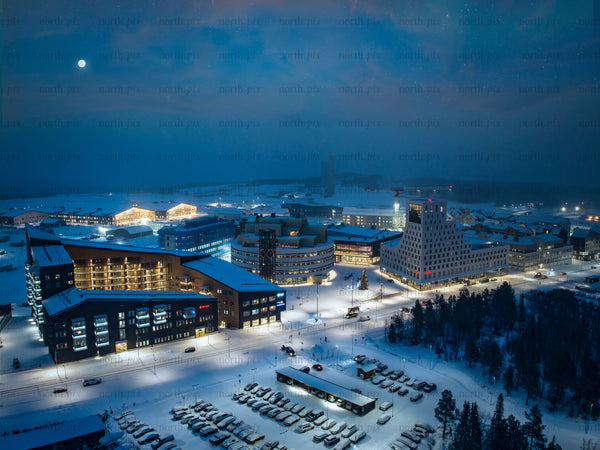 Night view of Kiruna centre snowy town with modern and traditional buildings
