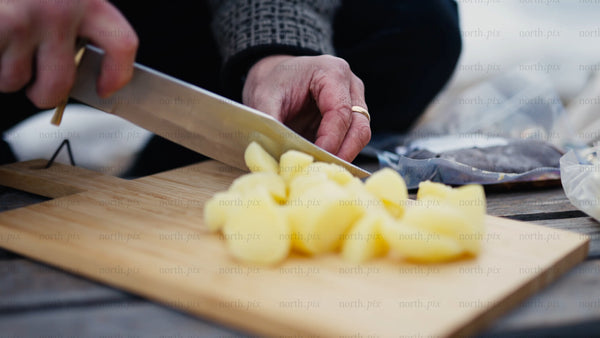 Cutting potatoes outdoors in winter, Luleå archipelago
