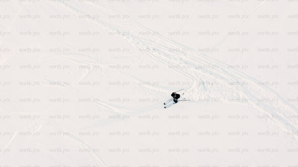Aerial view of skiing downhill on snowy slope in riksgransen