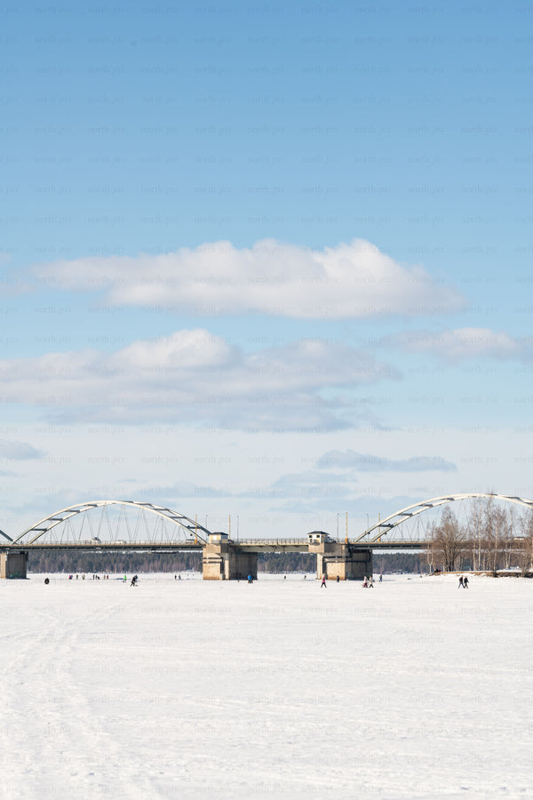 Bridge over a frozen river on a winter day