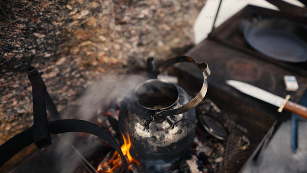 Making hot tea over a fire in the winter Luleå archipelago