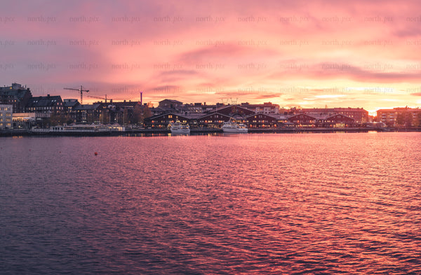 Harbor skyline at sunset with waterfront buildings