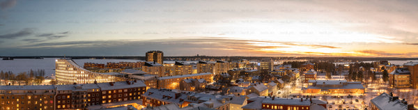 Snow-covered city skyline at winter sunset