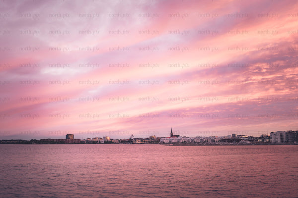 Harbor skyline with church spire at sunset