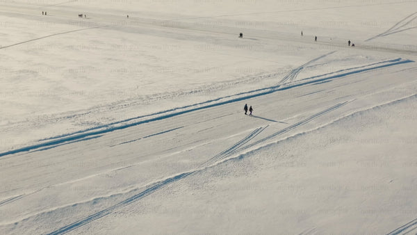Winter wonderland in Luleå: Aerial drone footage of snowy landscape and frozen lake activities