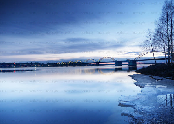 Bridge over calm water during winter twilight in Luleå