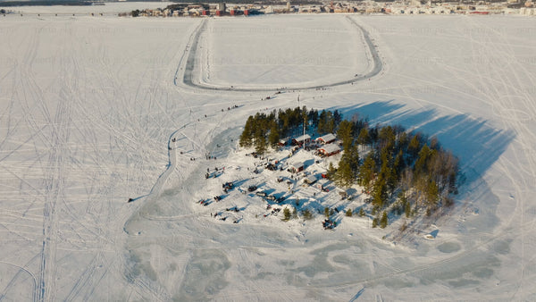 Winter in Luleå: Aerial view of frozen lake, island gathering, and ice skating track