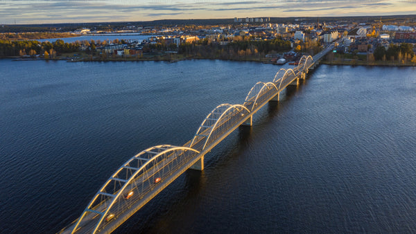 Golden hour timelapse of Luleå city and bridge: Aerial sunset view of Sweden in autumn