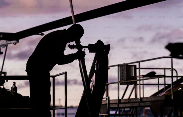 Helicopter maintenance worker at sunset