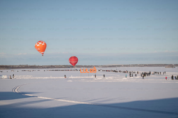 Hot air balloons over frozen lake in Luleå