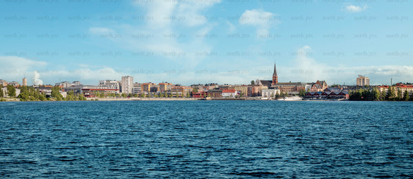 Summer city skyline across waterfront with church steeple