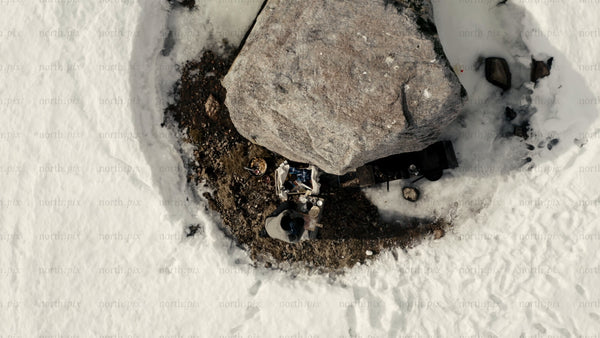 Man cooking outdoors in winter landscape, Luleå archipelago