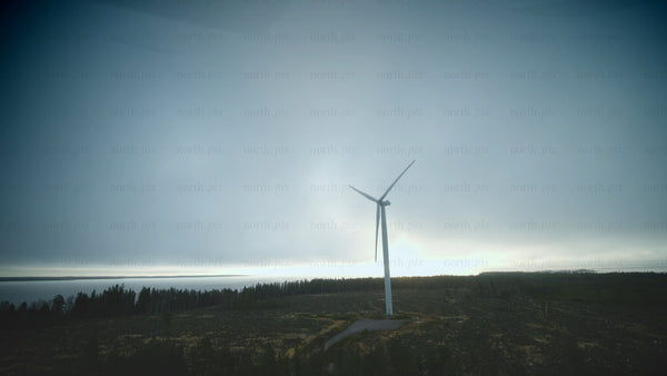 Rotating wind turbine by the sea: Aerial view of sustainable energy in Finland