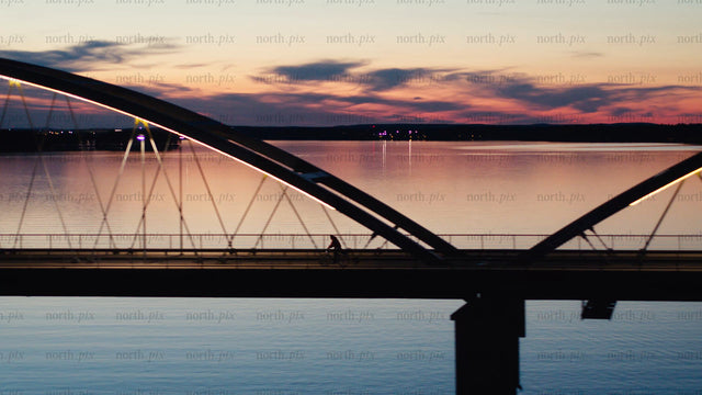 Sunset bike ride across Luleå bridge: An aerial view of summer
