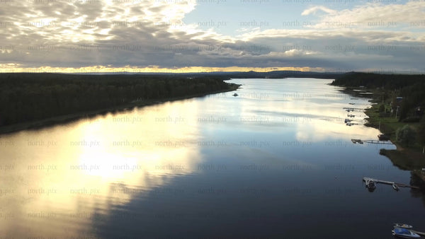 Aerial view of Piteå archipelago landscape with golden sunset reflections on calm water