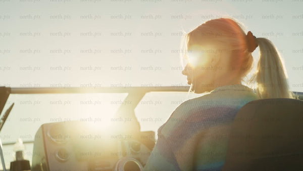 Woman driving boat at golden hour in the Luleå archipelago