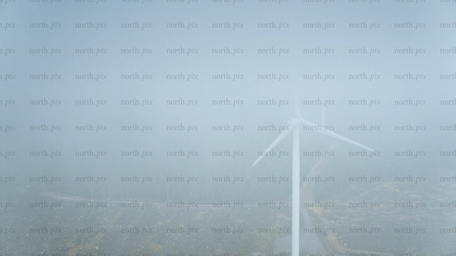 Wind turbine in foggy forest near ocean in Haraholmen