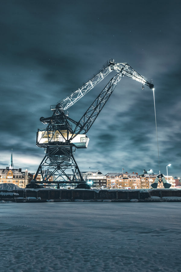 Luleå industrial harbor crane at night in snowy city