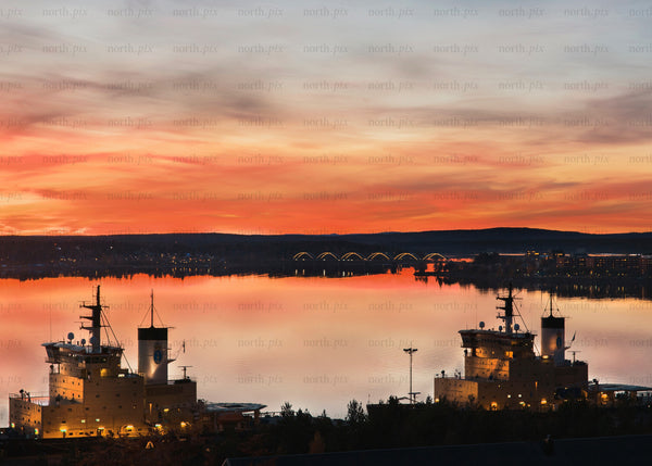 Sunset view of ships and bridge in Luleå harbor during autumn