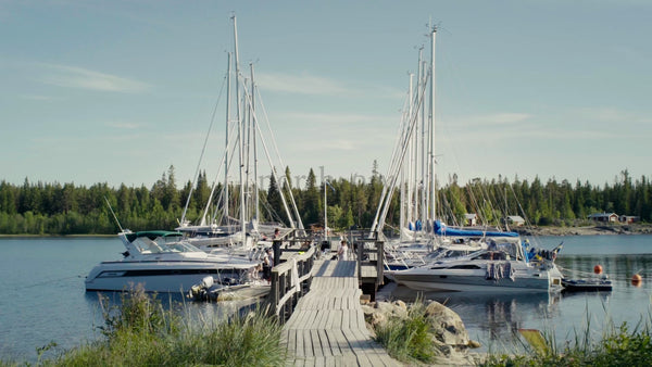 Summer Day at Kluntarna Archipelago: Sailboats and Motorboats Moored at Wooden Dock, Lulea, Sweden