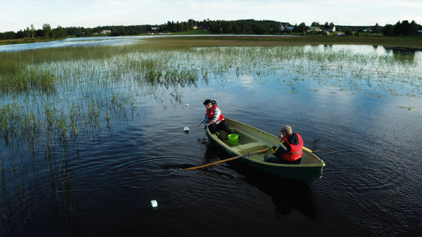 Crayfish traps being set in a lake in Sweden on a summer day