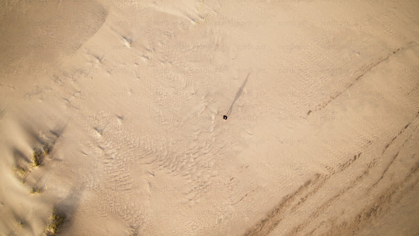 Summer day in Skvalpen archipelago: Person walking on sandy dunes in Luleå