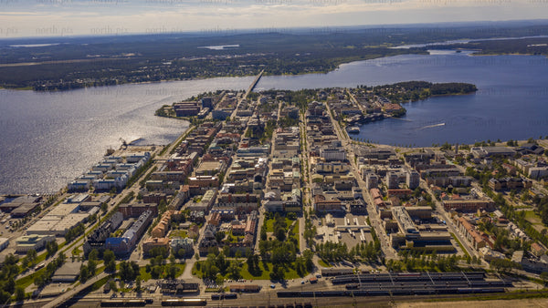 Aerial summer day timelapse of Luleå: Cityscape, river, and boats