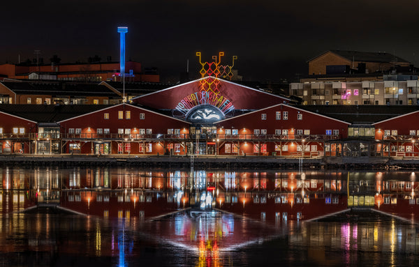 Night view of red waterfront theater with reflections