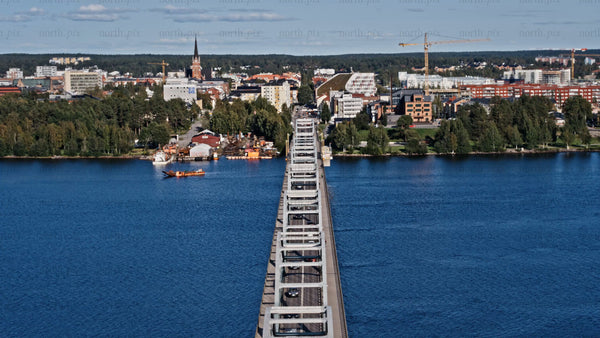 Aerial view of Luleå: Cars driving across Bergnäsbron bridge on a summer day