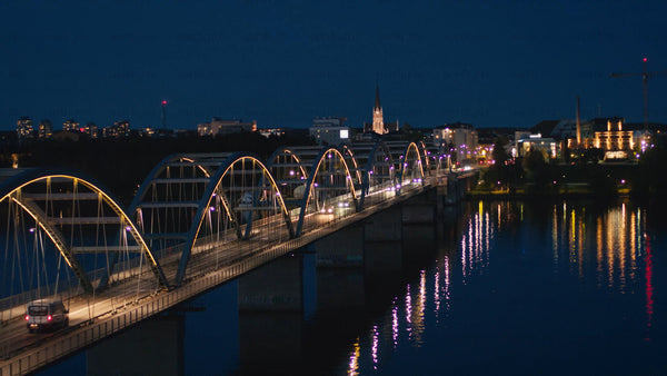 Luleå cityscape at twilight: Cars crossing bridge over river