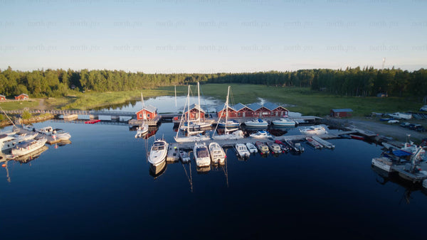 Summer evening in Junkön, Luleå archipelago: Boats moored at a harbor