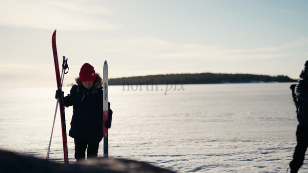 Winter Cross-Country Skiing Preparation on Frozen Lake in Luleå Archipelago, Sweden