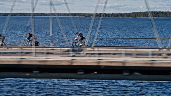 Cyclists on Bergnäsbron bridge, Luleå, summer day, active lifestyle