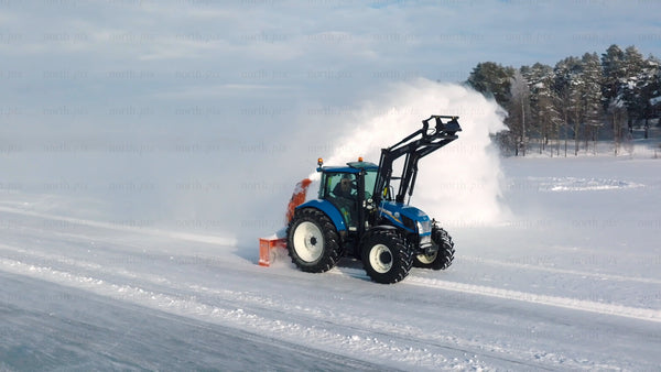 Tractor clearing snow on frozen lake in Luleå