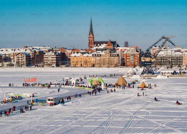 Winter day in Luleå Sweden with frozen lake and colorful buildings