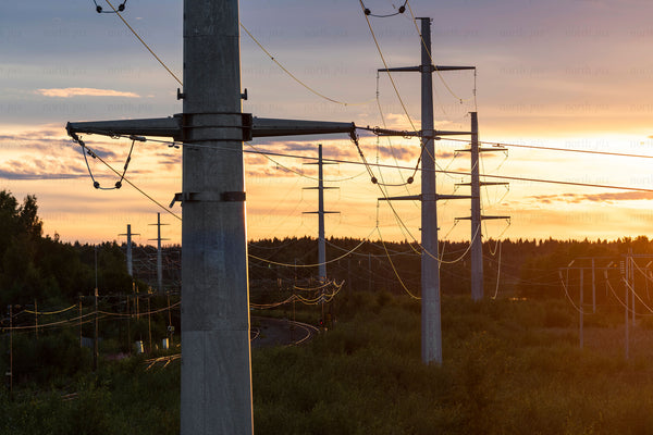 Power lines and concrete poles at sunset