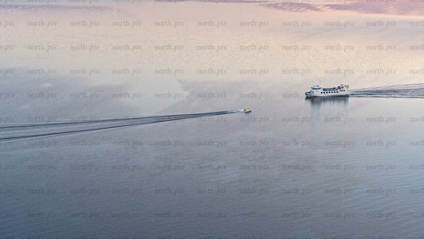 Luleå river sunset: Boats sailing on calm water