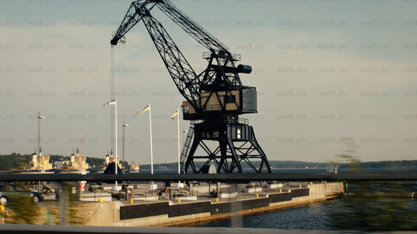 Luleå industrial harbor: A daytime aerial view of cranes and parked cars