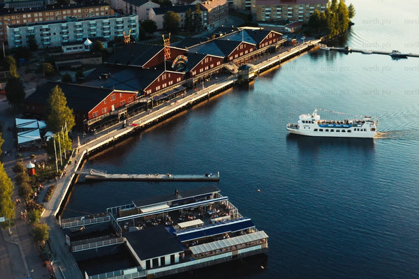 Aerial view of Luleå city center harbor with boats and red waterfront buildings