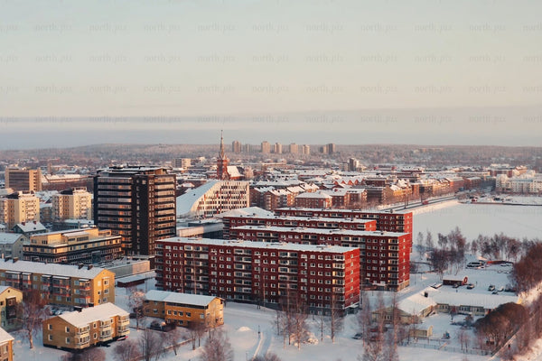 Snowy Luleå city center aerial view of modern red and brown buildings in winter