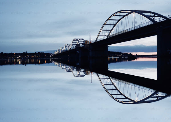 Bridge reflected during blue hour evening over calm waters in Luleå