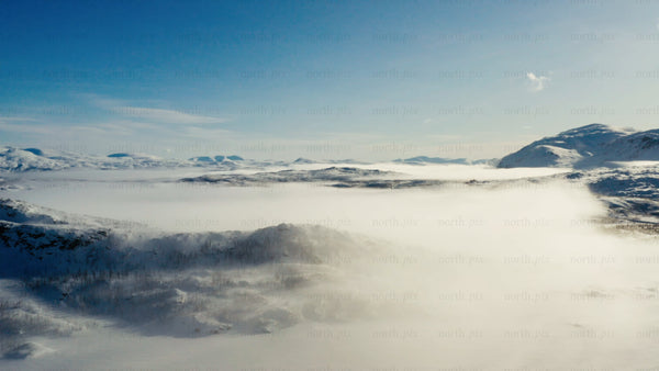 Riksgränsen: Aerial view of winter landscape with snow and clouds