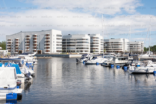 Marina with waterfront apartment buildings at midday