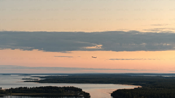 Aerial sunset view of Luleå archipelago: Plane soaring over calm waters
