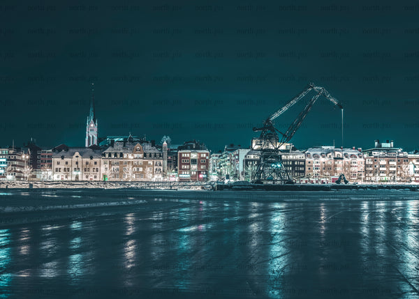 Night waterfront with industrial crane and church steeple